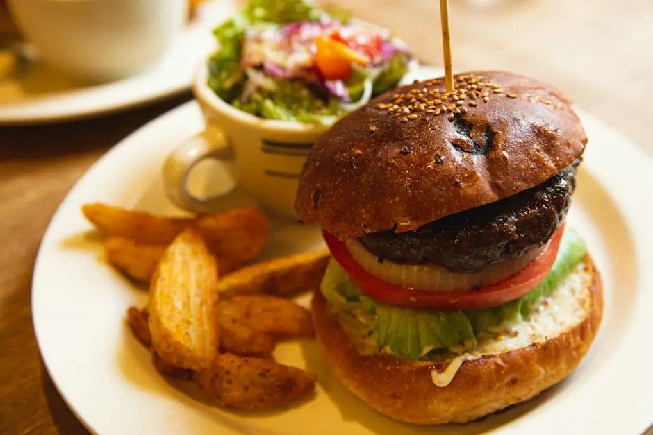 A delicious black bean burger stacked with lettuce, tomato, and avocado, served on a toasted bun.