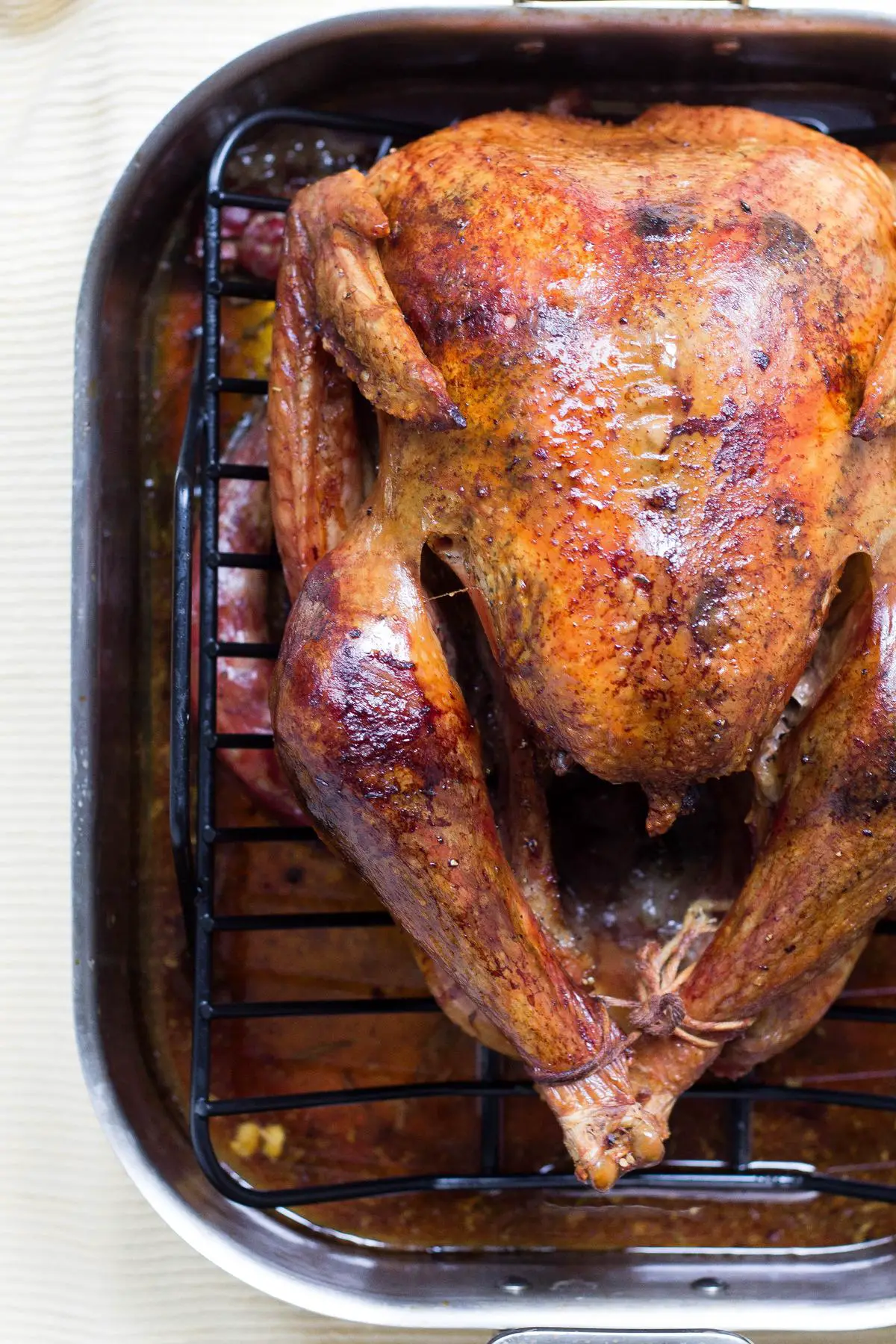 A deliciously seasoned rotisserie chicken displayed with golden brown skin.