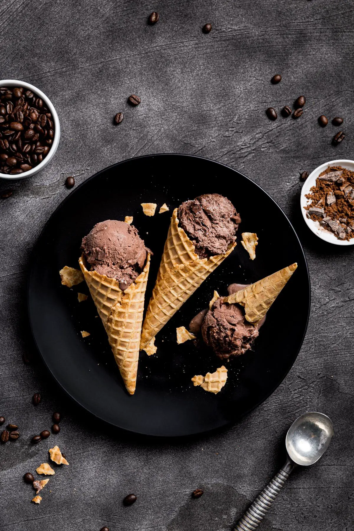 A close-up image of a delicious Drumstick ice cream cone with chocolate, nuts, and a crunchy sugar cone.