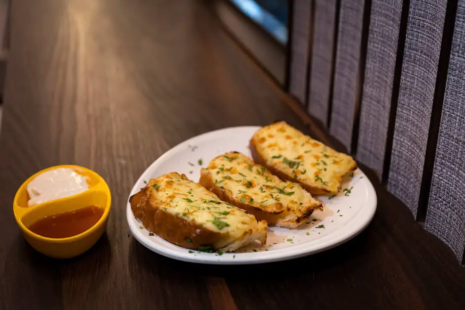 A close-up image of a golden and cheesy garlic bread on a plate, ready to be served
