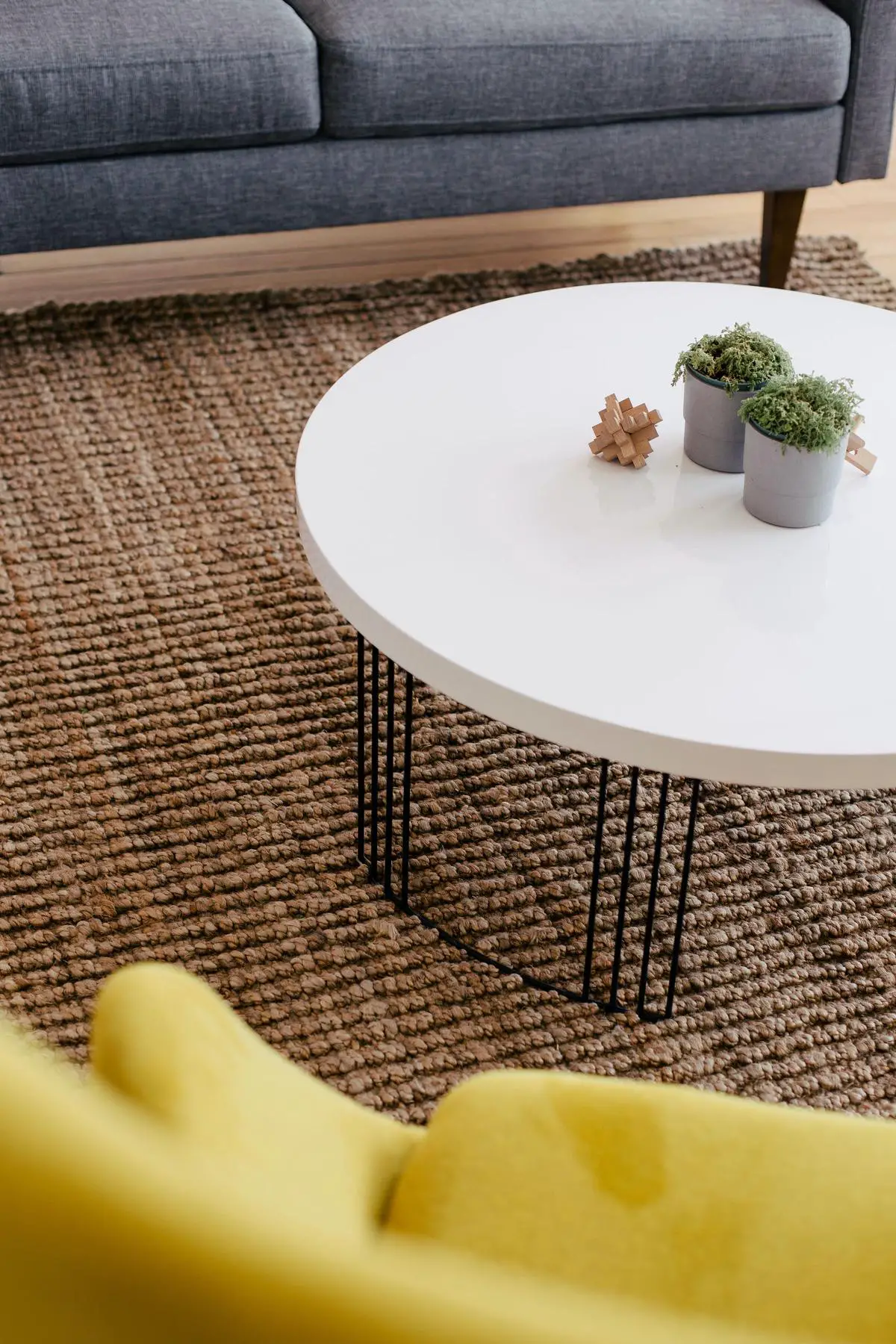 A beautifully customized IKEA coffee table with hairpin legs, storage baskets, and a marbled tabletop.