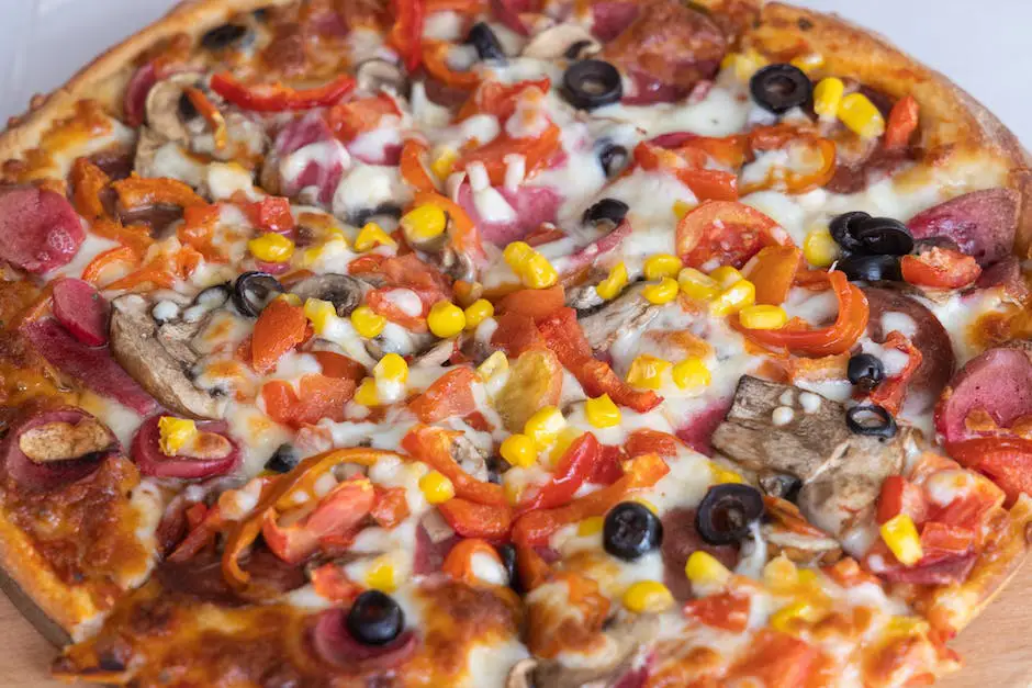 A mouth-watering image of a freshly baked pizza with a variety of traditional toppings such as melted mozzarella cheese, pepperoni, bell peppers, sausage, mushrooms, and basil leaves.
